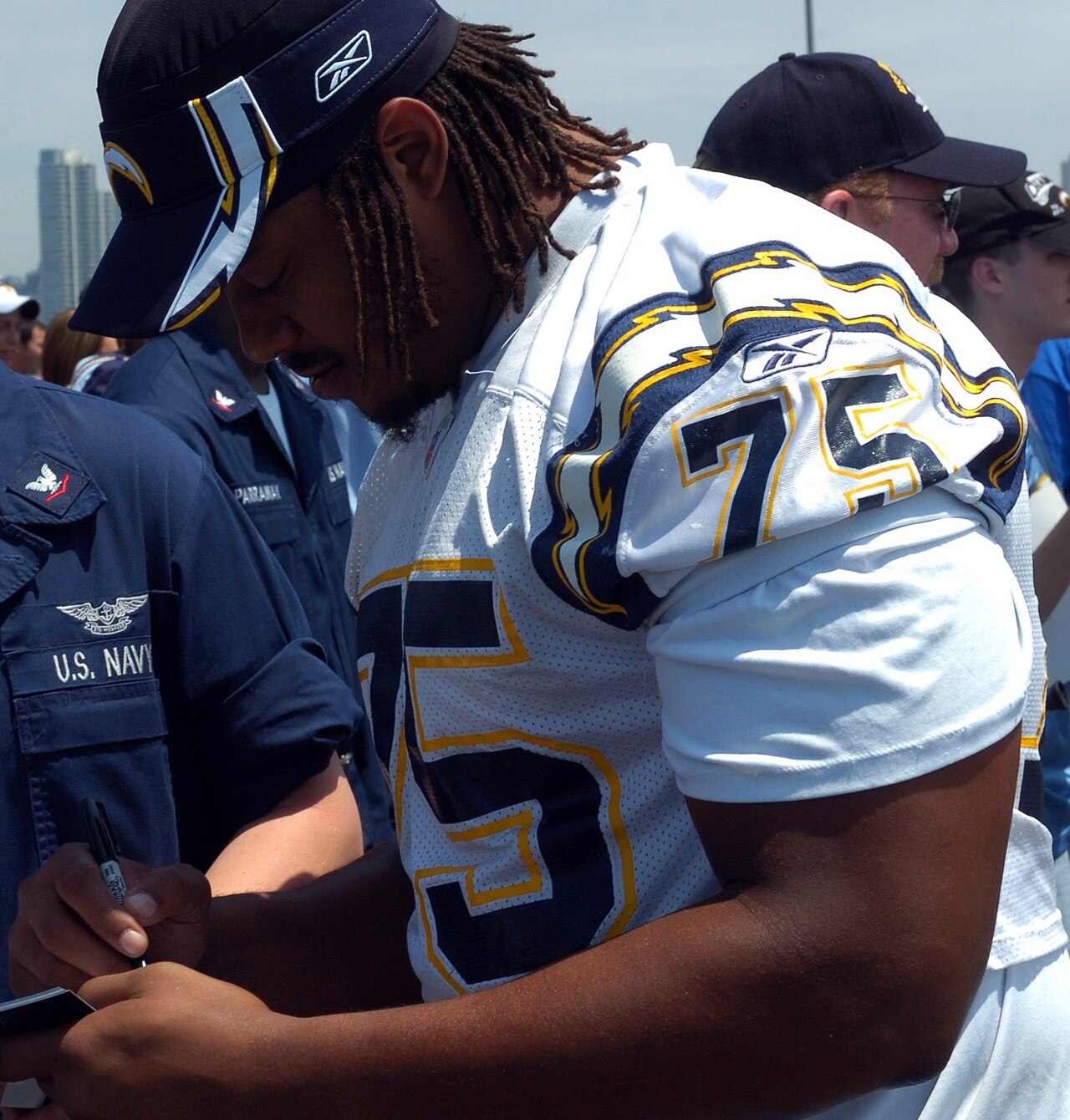 Leander Jordan signing autographs in his #75 jersey during his NFL career